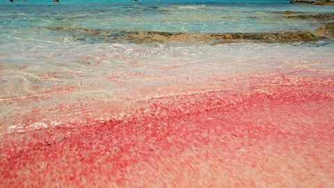 The beautiful and rare pink sand and crystal clear waters of the Balos beach in Crete, Greece