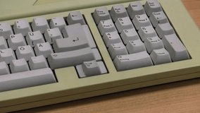White computer keyboard. Computer or game console from the 90s. Old retro style. 4k, Panning, closeup. 