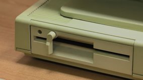 Floppy Disk Drive. Computer or game console from the 90s. Old retro style. 4k, Panning, closeup. 