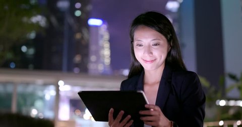 Business woman use of digital tablet computer at night