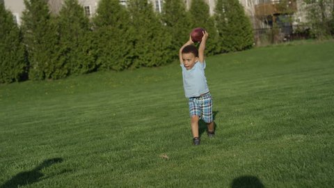 Little boys playing football together: stockvideo