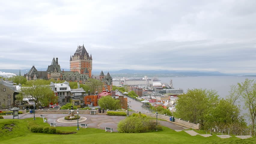 Cityscape or skyline of Quebec City, Canada old town streets green park with cloudy gray stormy sky, Chateau Frontenac, Dufferin Terrace and St Lawrence River, people walking