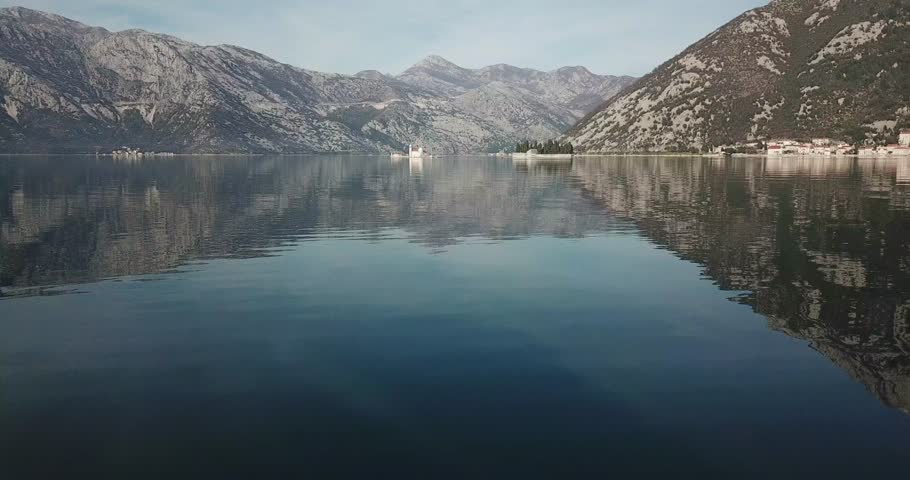 Old town Kotor, Montenegro on the coast of Kotor Bay of Adriatic sea. Old castles, ancient city walls, churches with the mountains and bay on the background. Spectacular aerial footage.