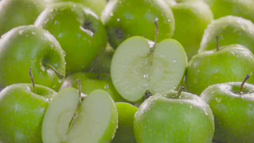 Green apple falling in juice with splash between apples. Slow motion 480 fps Royalty-Free Stock Footage #1011538595