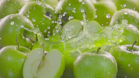 Green apple falling in juice with splash between apples. Slow motion 480 fps - Powered by Shutterstock - Get 15% off with code: PIKWIZARD15