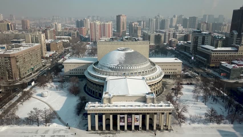 Aerial - view of the beautiful opera and ballet theater from the air. Novosibirsk State Academic Opera and Ballet Theater. Winter view of city. 4k