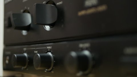 Hi-Fi home audio system - adjusting tuning bass treble volume stereo amplifier receiver - close-up