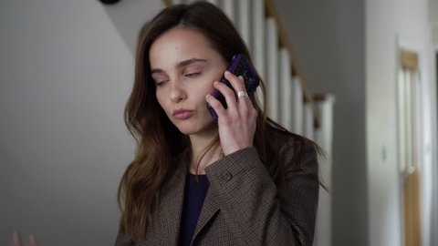 Pretty Business lady talks on phones then hangs up. Handheld of attractive young millennial businesswoman talking on phone then hanging up