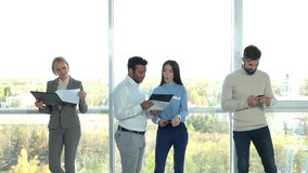 Two managers talking against bright windows background. Young bearded man and office lady leaving away. - Powered by Shutterstock - Get 15% off with code: PIKWIZARD15