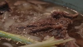 Close up shot of boiling beef soup.