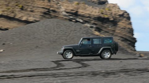 VIK, ICELAND - MAY 03, 2018. Jeep Wrangler Unlimited Sport four wheel drive vehicle being used on terrain on a black sand beach in Iceland