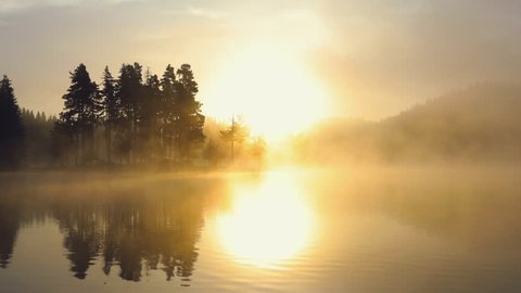 Morning fog on the mountain lake, sunrise shot