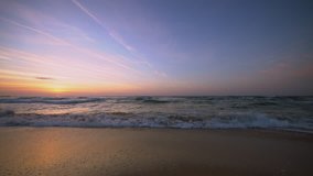 Beautiful sunrise over the sea, splashing waves video