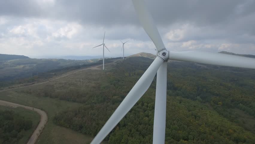 green meadow whit wind turbines aerial view