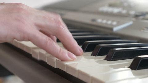 Musician playing synthesizer. the musician plays the piano. female hands play the synthesizer. 4k, slow motion