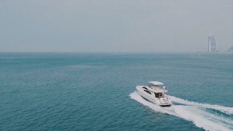 Holiday on a large white yacht with a beautiful view of Dubai. 4K cinematic video from drone