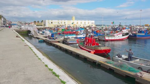 Setubal, Portugal - Circa April 2018: Walking Along the Embankment of the Fishing Port with Moored Boats