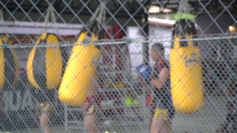 Blurred Motion background of Muay Thai Boxer in training at the Boxing Gym.Kick boxing is culture tradition fighter boxing of Thailand.