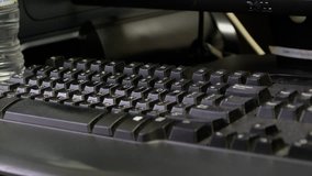 Close up view of unidentified man hand typing on a black keyboard.