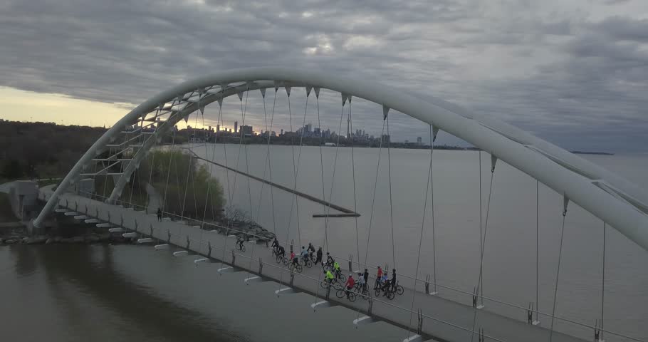 Toronto sunrise humber river bridge overcast overlook downtown camera panning left biker pass 4K