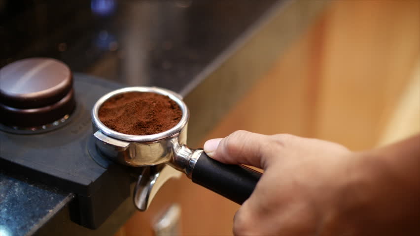 Making Ground Coffee with Tamping fresh coffee. Close-Up. Making coffee from start to finish.Tamping Fresh Ground Coffee. Professional barista. | Shutterstock HD Video #1011601349