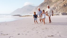 Grandparents Chasing Grandchildren Along Beach On Summer Vacation - Powered by Shutterstock - Get 15% off with code: PIKWIZARD15
