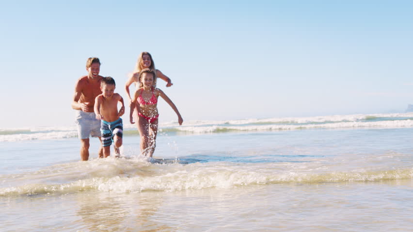 Parents and Children In Swimsuits Running Out Of Sea On Summer Vacation Royalty-Free Stock Footage #1011609854