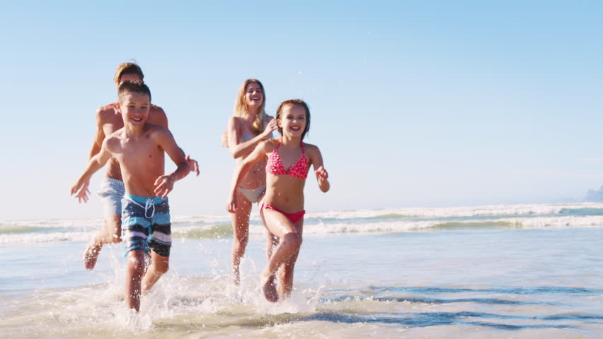 Parents and Children In Swimsuits Running Out Of Sea On Summer Vacation | Shutterstock HD Video #1011609854