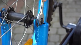 Young boy screwing bicycle wheel - Powered by Shutterstock - Get 15% off with code: PIKWIZARD15