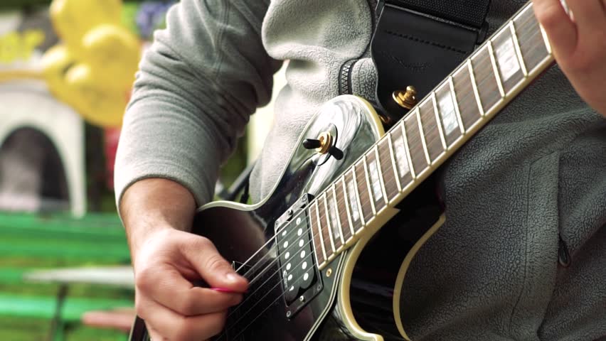 The guitarist plays on the street