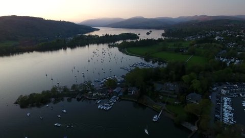 Aerial view over beautiful lake with mored boats and yachts on Windermere District UK Englands. Sunset over mountain landscapes in Britain. 