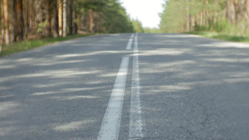 Young beautiful woman hitchhiking standing on the road with a backpack on a table with an inscription SOUTH 4k