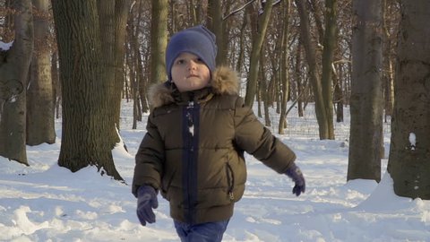 Portrait of cute adorable boy in winter park