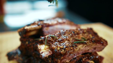 Close up of tasty beef ribs are being served in expensive restaurant, slow motion.
