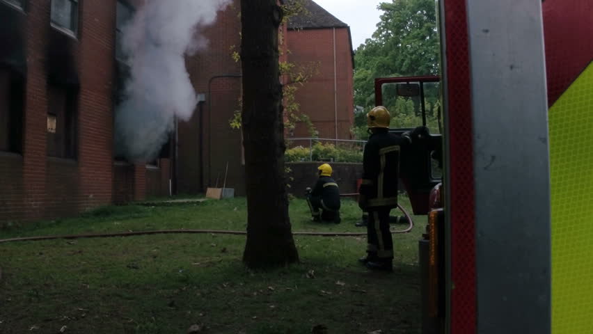 Firefighters drill with burning building