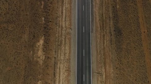 Road in the steppe. Road in the desert. Aerial view of a 2 lane road. Driving the long straight road through the desert 