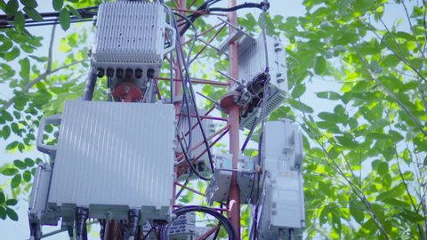 Telephone transmitter connection system with cellular phone antennas in rural areas.Telecom network base station.Telecommunication mast television post.Development communication.Footage 4k