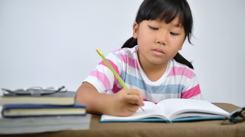 Asian girl student yawn and sleep while doing homework. education concept