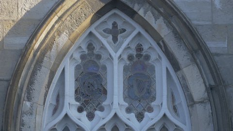 Dublin, Ireland - May, 2016: Close up of stained glass in a white window frame