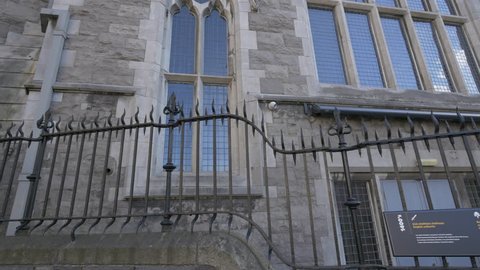 Dublin - May, 2016: Wrought iron fence and a stone building in Dublin