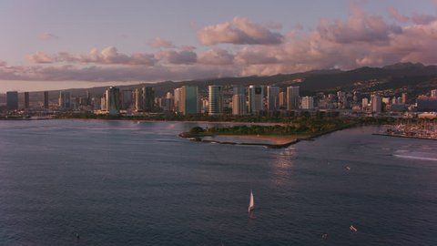 Honolulu, Oahu, Hawaii circa-2018. Aerial view of Magic Island in late evening sun. Shot with Cineflex and RED Epic-W Helium.