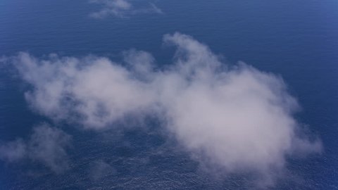 Oahu, Hawaii circa-2018. Aerial view of clouds over Pacific Ocean between Oahu and Kauai. Shot with Cineflex and RED Epic-W Helium.