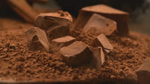 Chunks of chocolate falling into powdered chocolate, shot with Phantom Flex