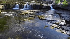 Waterfall in the Yorkshire Dales  landscape. Aerial video at Aysgarth, North Yorkshire Dales, England.