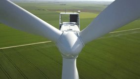 Raw drone video of a wind turbine on a wheat field