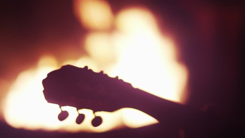 Guitar Neck Silhouetted At Bonfire