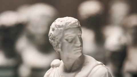 Focus changing between many famous roman sculptures busts made of marble. Closeup shots with focus pull.
