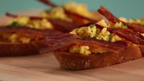Bread toast with scrambled eggs and bacon