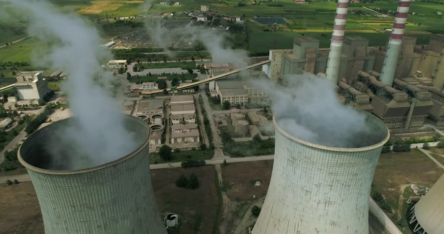 Flying over the plant producing electrical energy with large pipes at Kozani in northern Greece. Aerial shot, an Industrial Video by Ververidis Vasilis