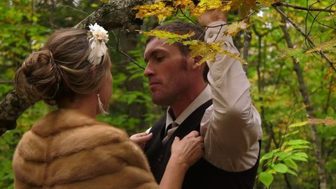 fur coat bride kisses her man in the woods 4k